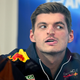 A photo of Max Verstappen pressing his face against glass.